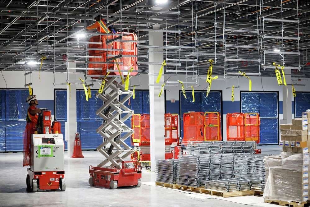 Comp-Utility technician on a scissor lift building out a facility